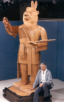 Artist with statue of the Great Silvery White Bear.
