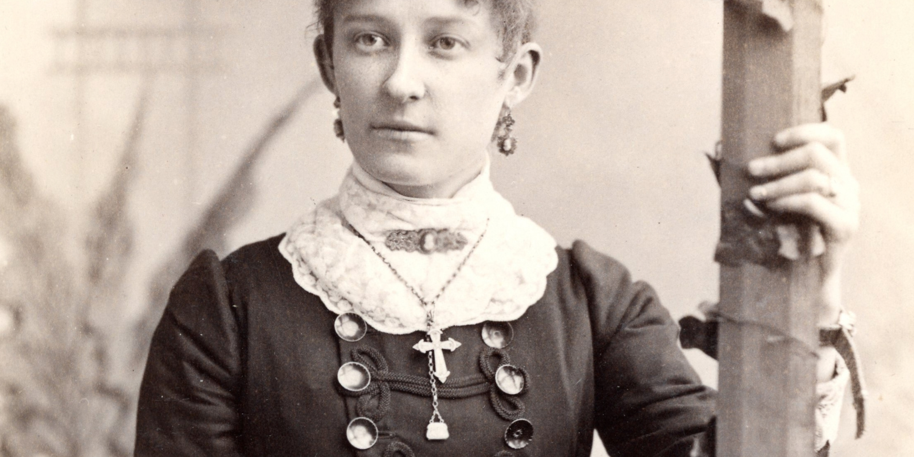 historical photo of a woman wearing many pieces of jewelry