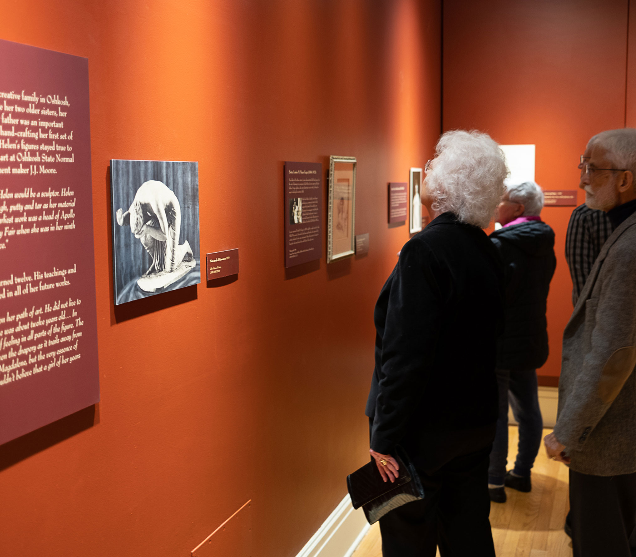 People viewing an exhibit of Helen Farnsworth Mears